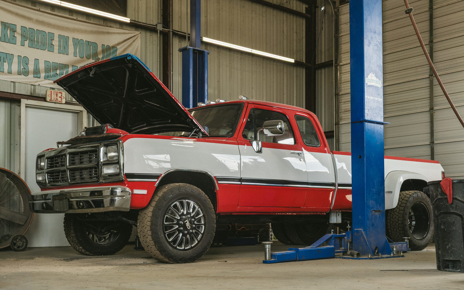 First-generation Dodge Ram Cummins dually on the lift with the hood up